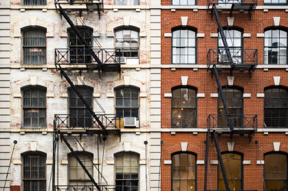 Close-up view of New York City style apartment buildings with emergency stairs along Mott Street in Chinatown neighborhood of Manhattan, New York, United States. stock photo