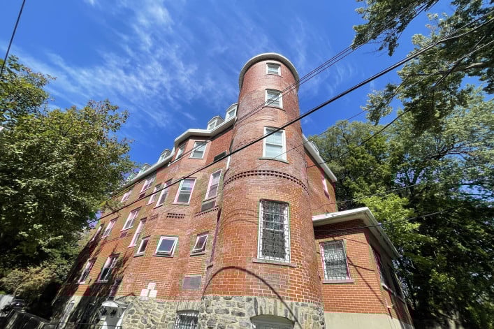 Boarding house Centro Maria reopened in Spuyten Duyvil in the Bronx after closing its Hell’s Kitchen location during the pandemic. A photo of Centro Maria's brick building in the Bronx.