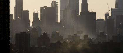 Steam emitting from building rooftops during winter in New York City.