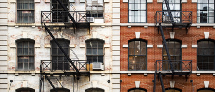 Close-up view of New York City style apartment buildings with emergency stairs along Mott Street in Chinatown neighborhood of Manhattan, New York, United States. stock photo