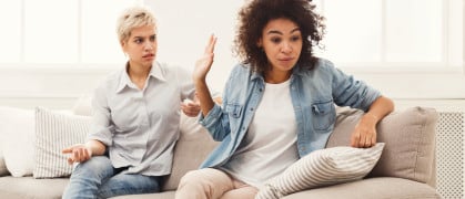 Roommates seated on a couch having an argument Roommates seated on a couch having an argument