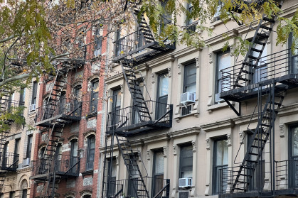 Old colorful buildings with fire ladder and trees on New-york manhattan, Upper East Side, buildings front house