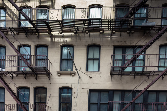 In Manhattan, a glimpse at a New York city residential building, with its famous exterior fire escape staircase.