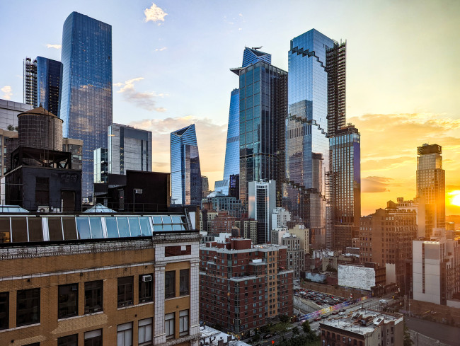 New York City - glass skyscrapers in Hudson Yards with sunlight shining in the skyline background