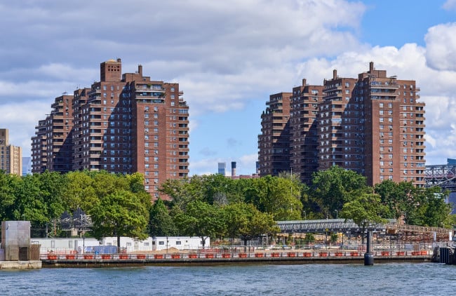 Towers of the East River Co-ops (1956) in the Lower East Side, NYC. In the foreground is the East River and East River Park under renovation. These were the tallest reinforced concrete apartment structures in the United States at the time of their construction.