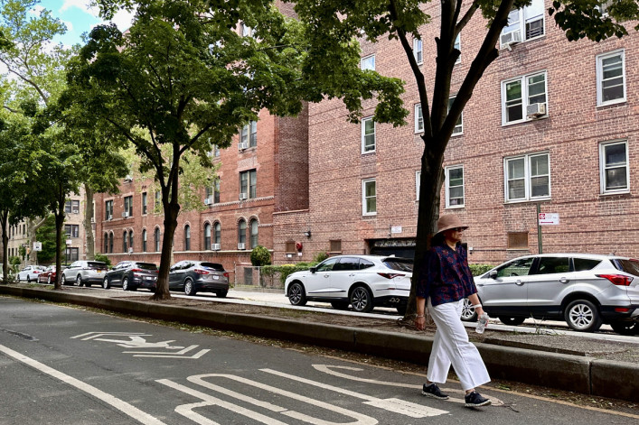 Woman walking down street in Jackson Heights Woman walking down street in Jackson Heights