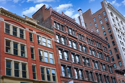 Row of three red brick apartment buildings in NYC