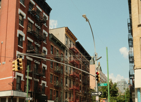 Red brick buildings with fire escapes in NYC