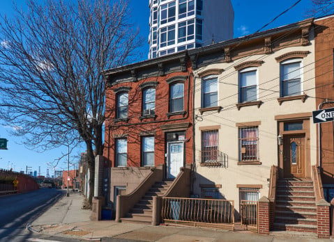 Brick rowhouses on Nelson St. in Carroll Gardens, Brooklyn, NYC adjacent to the expressway