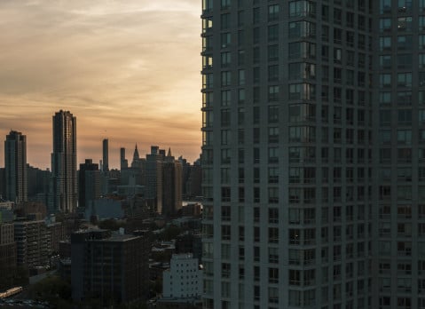 Evening view of Hunters Point waterfront and Manhattan over the East River from a modern condo in Long Island City, Queens.