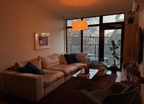 A cozy living room lit in orange light.