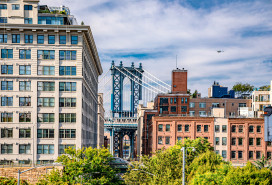 Dumbo is a vibrant Brooklyn neighborhood known for its artistic scene, offering spectacular views of the iconic Steel Manhattan Bridge. stock photo