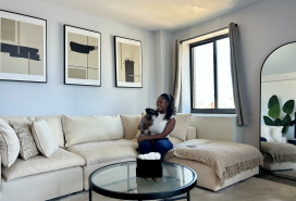 A photo of Kayla on her couch in the Bronx.