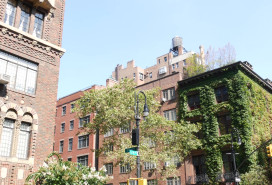 New York City classic building corner architecture. Urban residential house exterior. Real estate property in USA. Typical brick facade, Irving Pl, Manhattan Midtown. Rooftop water tower. Green wall.