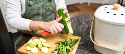 Women cooking uses compost bin