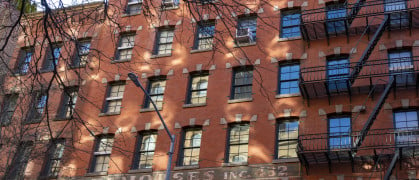 Greenwich Village, Manhattan, New York, USA -March, 2024. New York Warehouse apartment block. Classic exterior metal fire escapes on or near Greenwich Street in New York City.