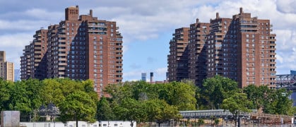 Towers of the East River Co-ops (1956) in the Lower East Side, NYC. In the foreground is the East River and East River Park under renovation. These were the tallest reinforced concrete apartment structures in the United States at the time of their construction.